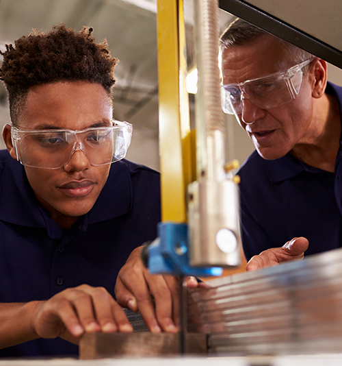 Image for Employers - A senior and junior technician working together on wood cutting machine.
