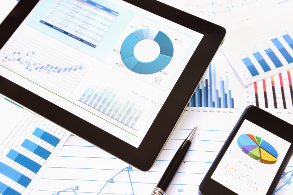 Trade reports block background image - Reports shown in table, mobile, and paper. style=